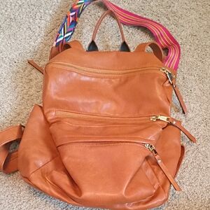 Stylish Tan Backpack with Colorful Strap